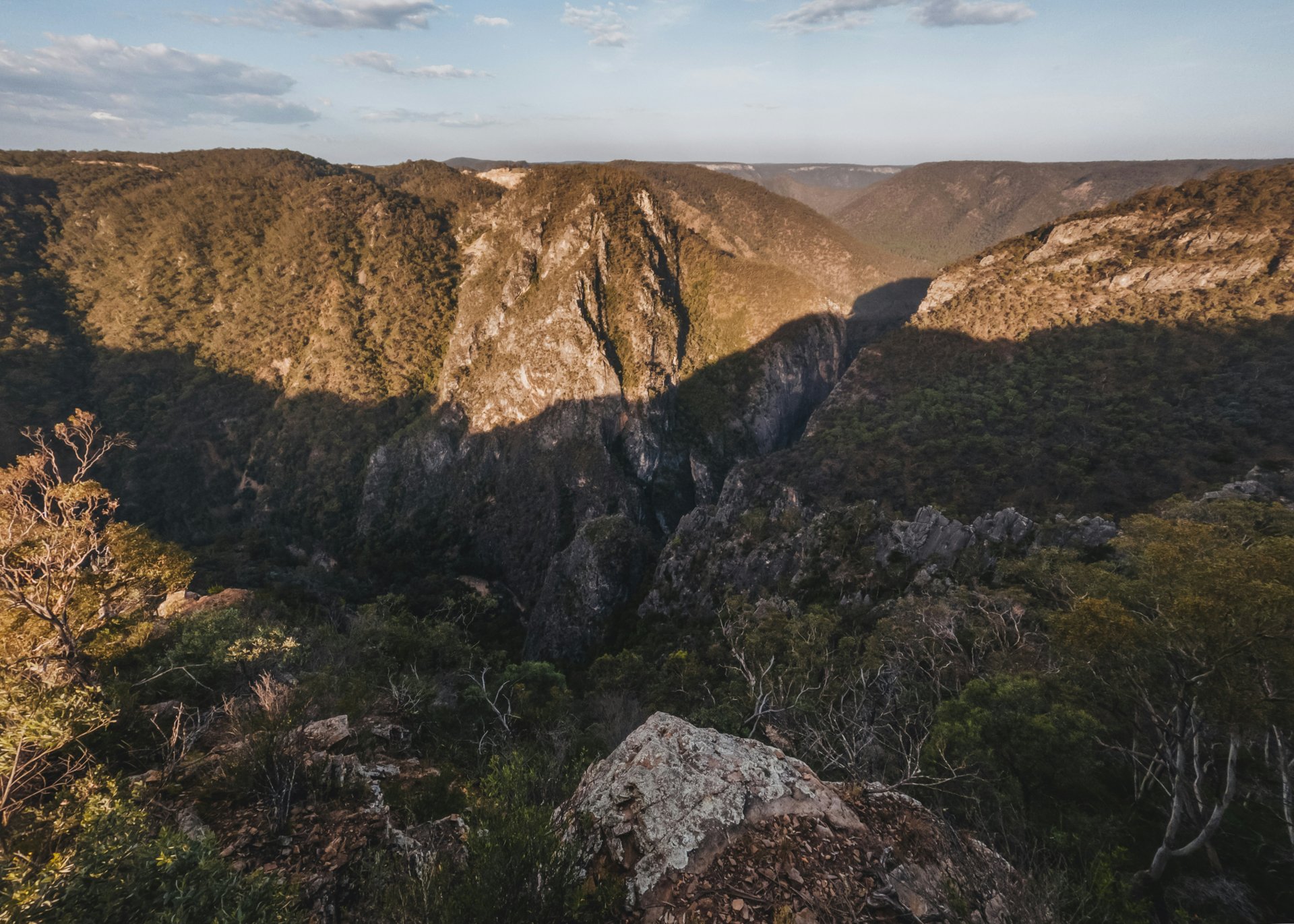 Dramatic western canyon landscape with golden sunset and rocky terrain